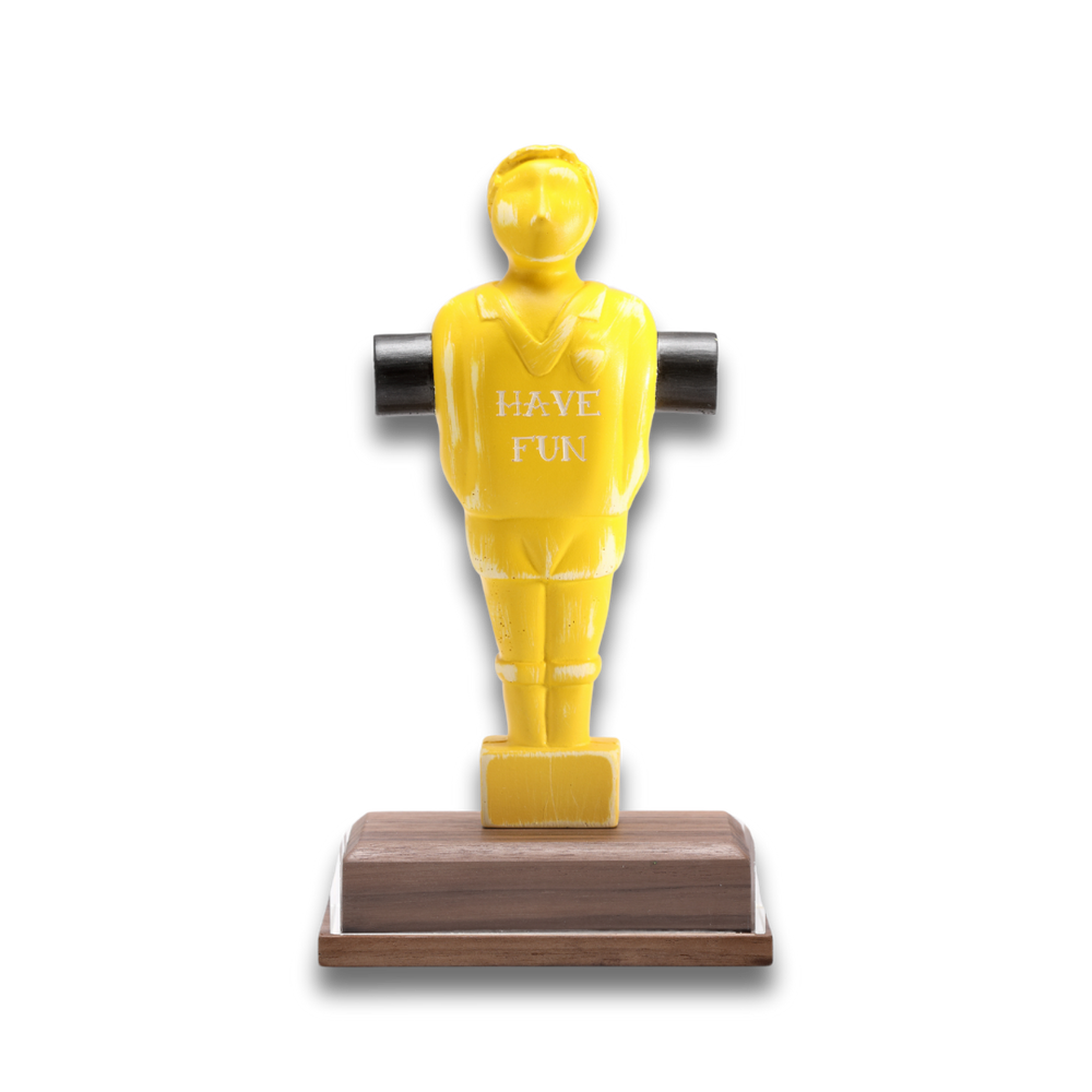 Statuetta gialla 'Have Fun' su sfondo nero